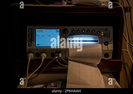 Woman hooked up to a fetal monitor measuring the baby girls vitals Stock Photo