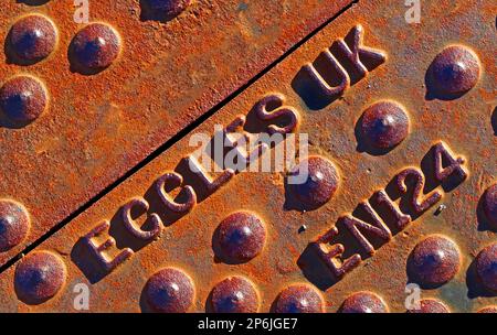 Cast iron, rusty Eccles embossed, street grid cover, Manchester / Salford Stock Photo