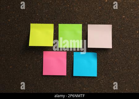 Empty colorful sticky notes on cork board Stock Photo