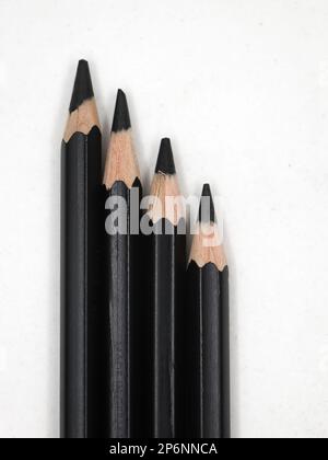 black sketching pencils with arranged in a slope in a white background Stock Photo