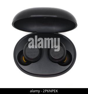 black wireless noise cancelling earbuds head set with a charging power bank case isolated in a white background Stock Photo
