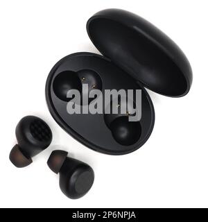 black wireless noise cancelling earbuds head set with a charging power bank case isolated in a white background Stock Photo