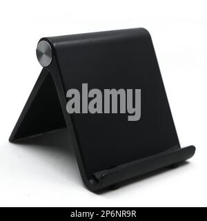 a black mobile phone holder stand which is foldable and adjustable for multiple angles isolated in a white background Stock Photo