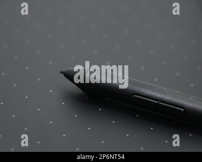 closeup of a black digital stylus touch pen tool on a sketching tablet used by artists and designers Stock Photo