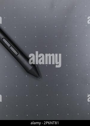 closeup of a black digital stylus touch pen tool on a sketching tablet used by artists and designers Stock Photo