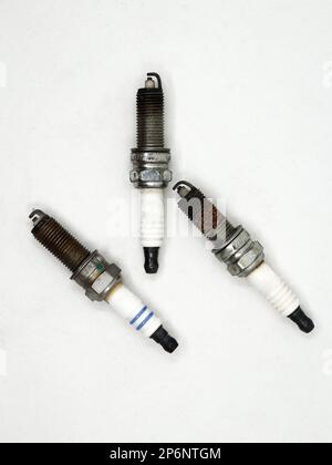 old rusty copper spark plugs used in automobile combuston engines isolated in a white background Stock Photo
