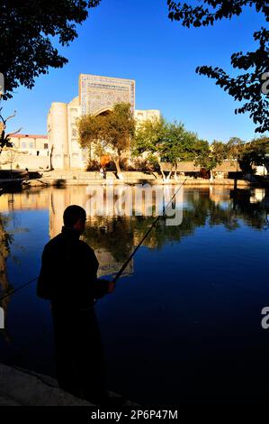 The Nodir Devonbegi Madrasah and the Divan-Beghi pond in the heart of the old city of Bukhara, Uzbekistan. Stock Photo