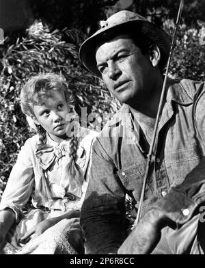 1960 , USA : The young actress HAYLEY MILLS  ( born 18 April 1946 London, England, UK  ) with RICHARD EGAN ( 1923 - 1987 ) in POLLYANNA  by David Swift , from a novel by Eleanor H. Porter and produced by Walt Disney Productions. . Pubblicity still  - FILM - CINEMA  - portrait - ritratto - trecce ---- Archivio GBB Stock Photo