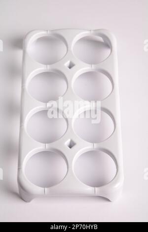photo of the egg storage item in the refrigerator on a white background Stock Photo