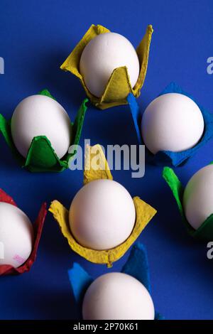 photo of eggs in colored packages on a blue background Stock Photo