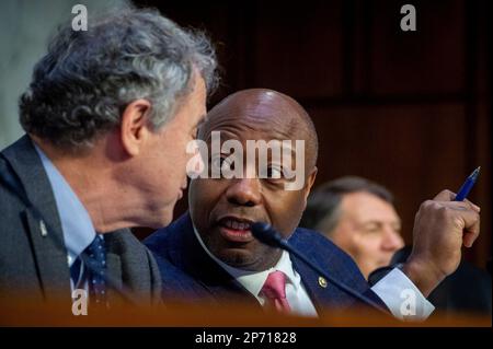 United States Senator Sherrod Brown (Democrat of Ohio), Chairman, US Senate Committee on Banking, Housing, and Urban Affairs, left, confers with United States Senator Tim Scott (Republican of South Carolina) as Jerome H. Powell, Chairman, Board of Governors of the Federal Reserve System, testifies during a Senate Committee on Banking, Housing, and Urban Affairs hearing to examine the Semiannual Monetary Policy Report to the Congress, in the Hart Senate Office Building in Washington, DC, USA, Tuesday, March 7, 2023. Photo by Rod Lamkey/CNP/ABACAPRESS.COM Stock Photo