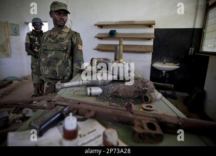 In a handout photograph released by the African Union-United Nations Information Support Team Monday, Aug.15, 2011, Ugandan soldiers serving with the African Union Mission in Somalia (AMISOM) sort through a bag of hand grenades and other munitions that were used by the extremist group Al Shabaab to make improvised explosive devices. AMISOM troops and Transitonal Federal Government (TFG) forces dislodged remnants of Al Shabaab from the site following the withdrawal of most of the extremist group's forces from the city ten days ago, discovering the bomb making facility at the former steel factor