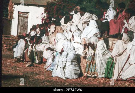 Lalibela, Ethiopia - June 24, 1998: people watch the morning ceremony in Lalibela where the priest presents the holy Ark of the Covenant at a yearly o Stock Photo