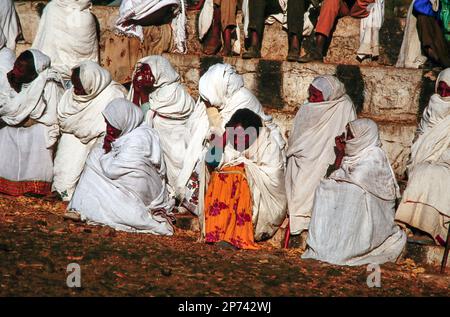 Lalibela, Ethiopia - June 24, 1998: people watch the morning ceremony in Lalibela where the priest presents the holy Ark of the Covenant at a yearly o Stock Photo