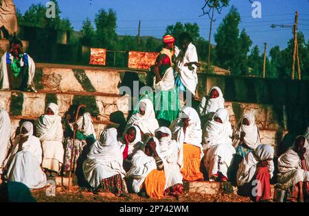 Lalibela, Ethiopia - June 24, 1998: people watch the morning ceremony in Lalibela where the priest presents the holy Ark of the Covenant at a yearly o Stock Photo