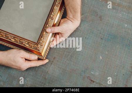 Framing Workshop. Making assembly stapler brackets baguette handmade picture frame at studio. Stock Photo