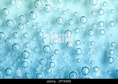 Macro Carbon dioxide (CO2) bubbles in water on a blue background, ecology concept Stock Photo