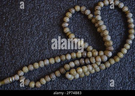 Ramadan and Islamic background concept of Muslim rosary beads for greetings card or banner with space for text Stock Photo