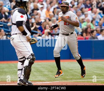 Toronto Blue Jays catcher Jose Molina (8) is congratulated by teammates  Edwin Encarnacion (12) and Aaron Hill (2) after a homerun against the  Minnesota Twins at the Rogers Centre in Toronto, Ontario. (