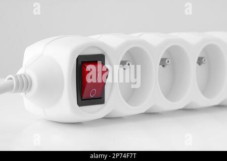 Electrical extension cord. White plug socket with switch Stock Photo