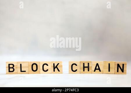 Blockchain text on wooden cubes, cryptocurrency,technology binary code, ditigal data and secure money, ledger bitcoin concept copy space background Stock Photo