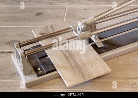 Hand tile cutter with tile. Stock Photo