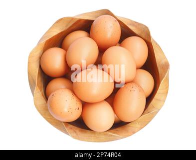 Top view of fresh home grown eggs in wooden bowl isolated on white background Stock Photo