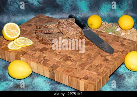 Wooden board for cutting handmade products with chopped vegetables. On a light background. Stock Photo