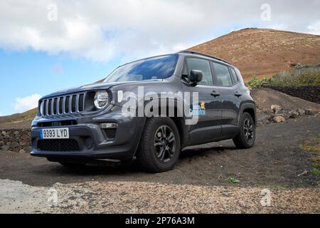 jeep renegade hire car off road on dirt road beneath a volcano in Lanzarote, Canary Islands, Spain Stock Photo