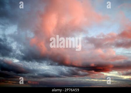 cloudy sky glowing pink and red due to setting sun Lanzarote, Canary Islands, Spain Stock Photo
