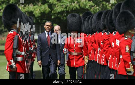 US President Barack Obama, center left, inspects the guard of honor 1st battalion Scots Guards with Britain's Prince Philip, center right, at Buckingham Palace in London, on Tuesday May 24, 2011. President Barack Obama and first lady Michelle Obama traded-in Irish charm for the pomp and pageantry of Buckingham Palace Tuesday as they opened a two-day state visit to Britain at the invitation of Queen Elizabeth II. (AP Photo/Adrian Dennis, Pool)