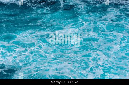 Waves hitting some rocks and creating big water columns Stock Photo