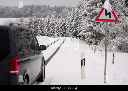 08 March 2023, Rhineland-Palatinate, Nürburg: After a winter blast, the roads in the Eifel region near the Nürburgring are covered in snow. Rain, snow and storms are expected to make the rest of the week quite uncomfortable, according to the DWD. Photo: Thomas Frey/dpa Stock Photo