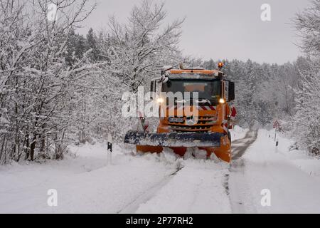 08 March 2023, Rhineland-Palatinate, Nürburg: A snow plow is on the road in the Eifel Mountains near the Nürburgring after a winter blast. Rain, snow and storms will make the rest of the week quite uncomfortable, the German Weather Service said Wednesday. Photo: Thomas Frey/dpa Stock Photo