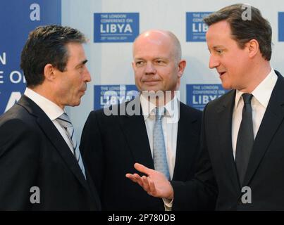 Britain's Prime Minister David Cameron, right, speaks with his Foreign Secretary William Hague, centre, and NATO Secretary General Anders Fogh Rasmussen at the opening meeting of the Libya Conference in London Tuesday March 29, 2011. International leaders plotted out an endgame Tuesday for Moammar Gadhafi's tottering regime, as British Prime Minister David Cameron accused the Libyan leader of shooting and starving his opponents into submission. (AP Photo/Stefan Rousseau/Pool)