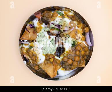 Samosa Chaat - Indian Pakistani Street Food Vegetarian Snack.  Made with Channa Aloo Mint Tamarind Chutney Yogurt Stock Photo