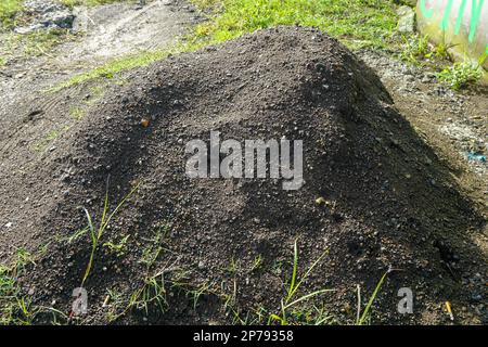 small mounds of black sand and wet gravel Stock Photo