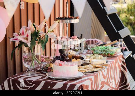 Candy bar with various sweets, cakes and pastries on the table, wedding candy bar. Stock Photo