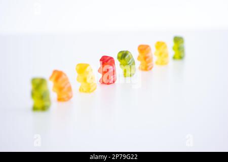Group of mix colored gelatin candy gummy bears isolated on white background shallow depth of field. Stock Photo