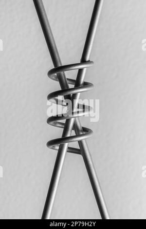 The letter x with a spiral in the middle made from steel wire. Stock Photo