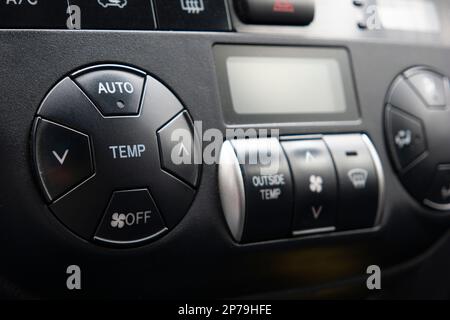 Generic car automatic climate control black plastic dials close up shot. Stock Photo