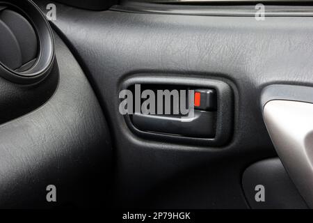 Generic car door open and lock lever close up shot. Stock Photo