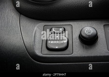 Generic car power side mirror adjustment switch panel close up shot. Stock Photo