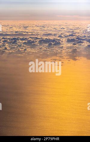 Clouds and sea at sunset, waves on the water, aerial view, flight over the Aegean, Greece Stock Photo