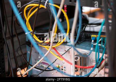 Messy connection computer and LAN cables power cord plugs. close up shot no people. Stock Photo