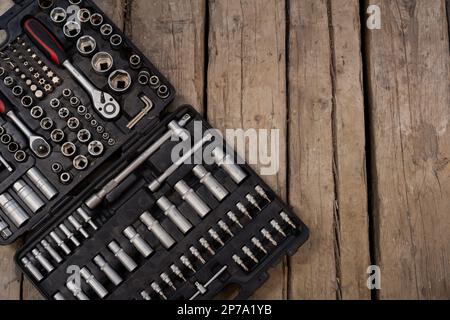 Set of wrenches and bits. Toolkit on the wooden board. Stock Photo