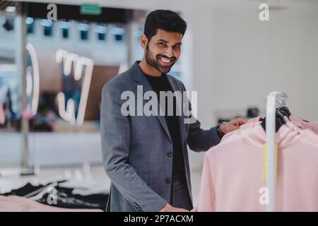 Young man working in clothing store Stock Photo