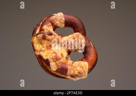 Freshly home backed Pretzel. Close up studio shot, isolated on gray. Stock Photo