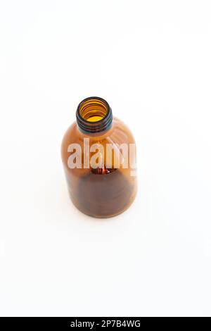Brown empty glass bottle. Pharmaceutical syrup bottle, close up studio shot, isolated on white, no people. Stock Photo