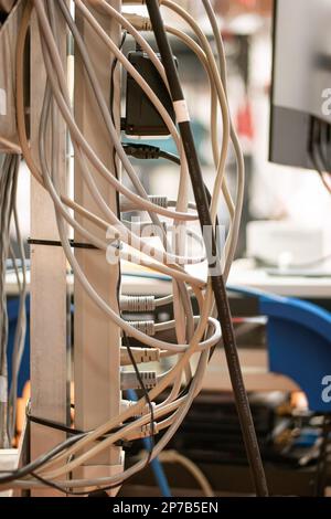 Power extension cord with multiple sockets, multiple power cords plugged in, inside a lab. Close up shot, shallow depth of field, no people. Neat and Stock Photo